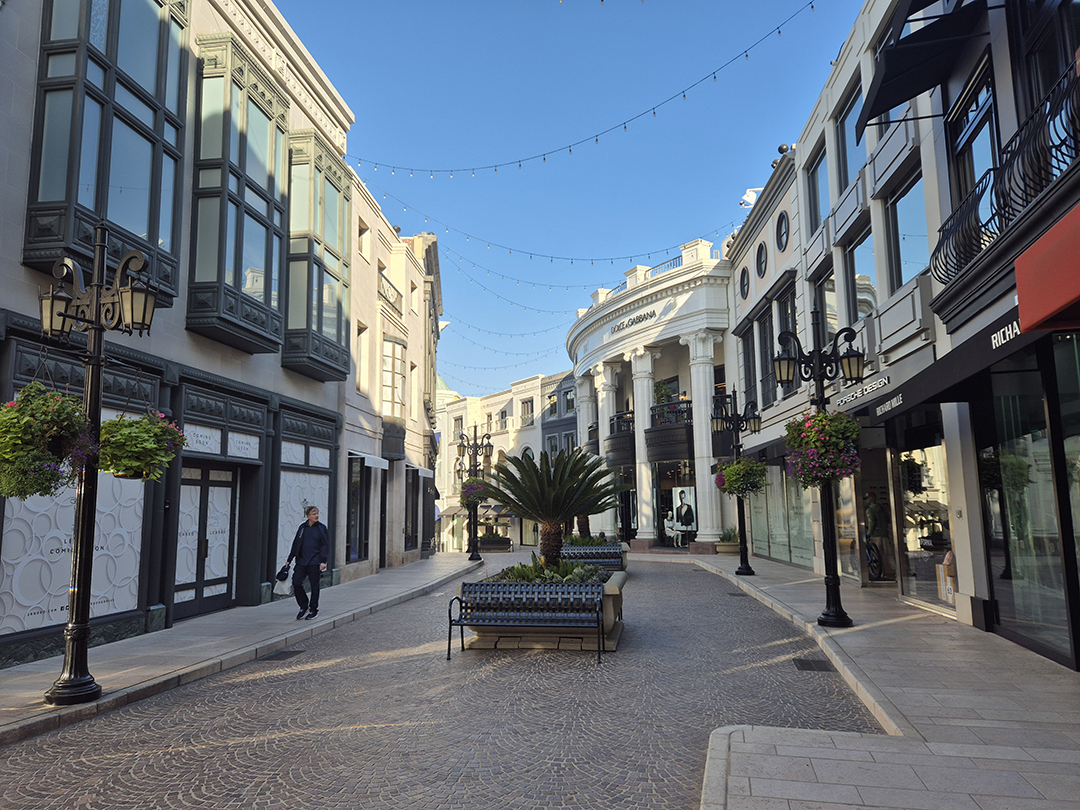 An elegant Beverly Hills street lined with luxury boutiques and refined architecture, characteristic of this exclusive LA district.