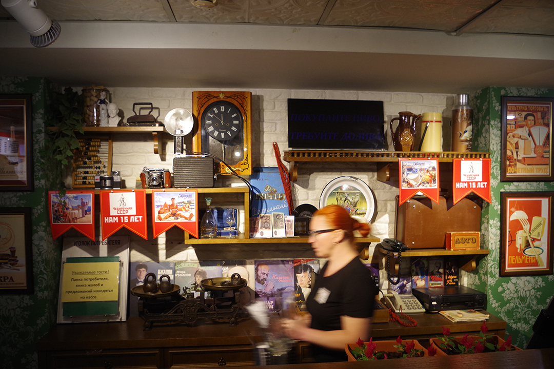 Interior of a Soviet-themed eatery decorated with memorabilia from the past.