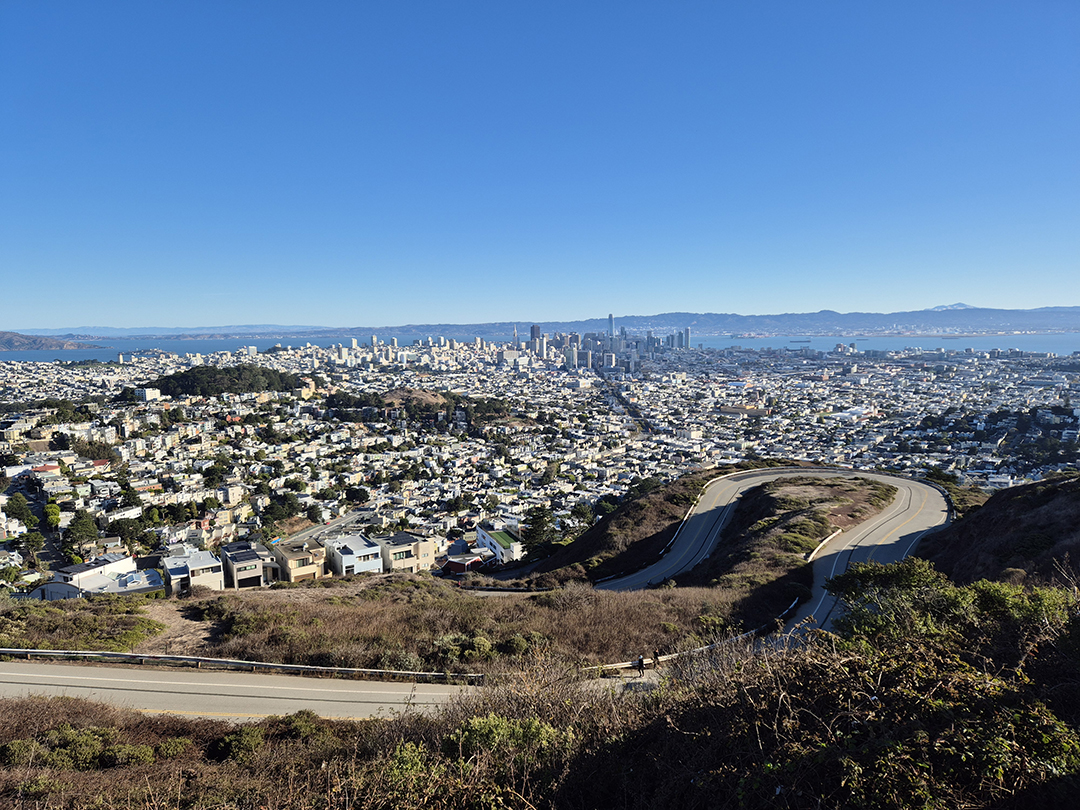 A panoramic view of San Francisco from Twin Peaks, showcasing the entire city and bay below.