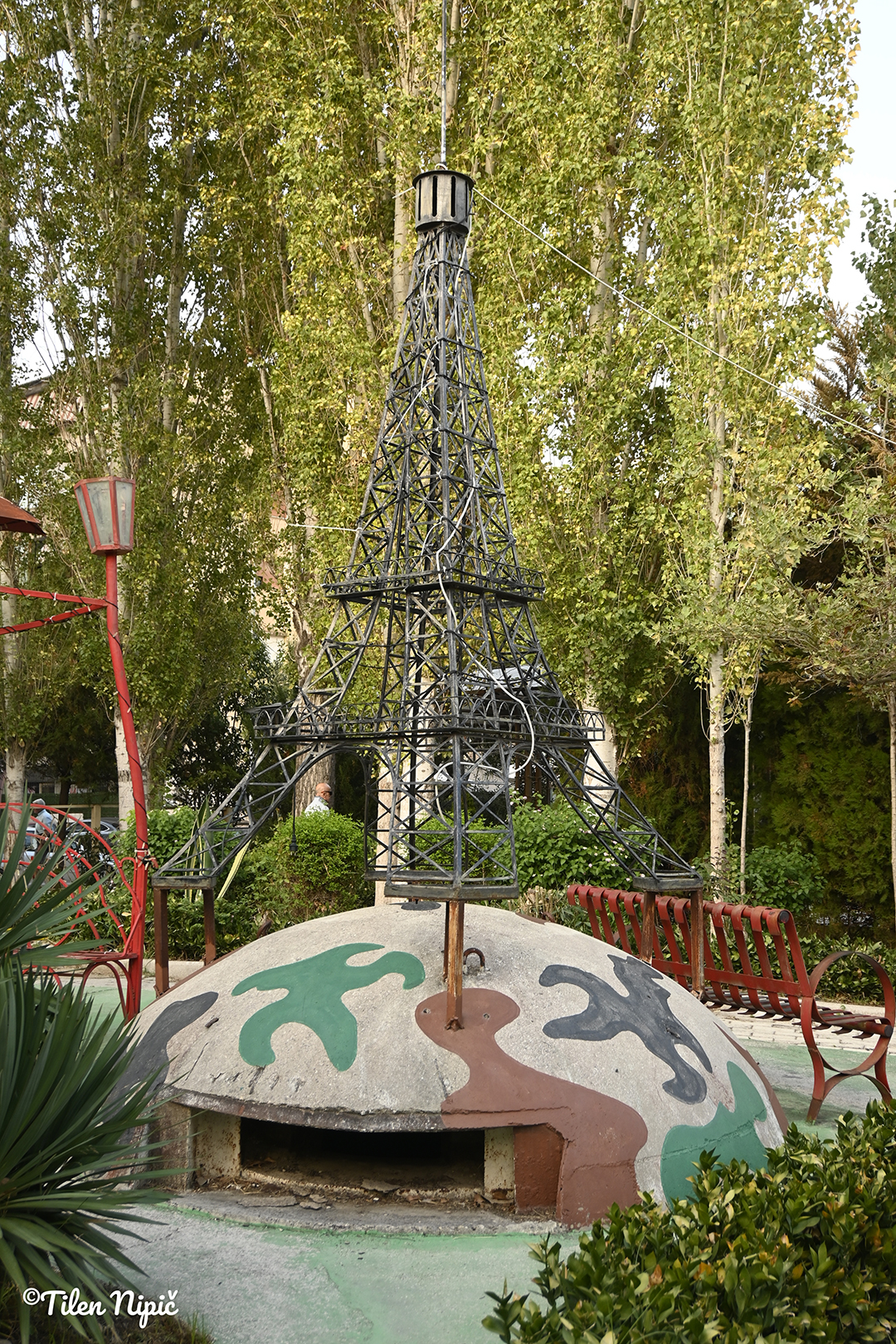A city park with a monument in Tirana offers a place to relax away from urban life.
