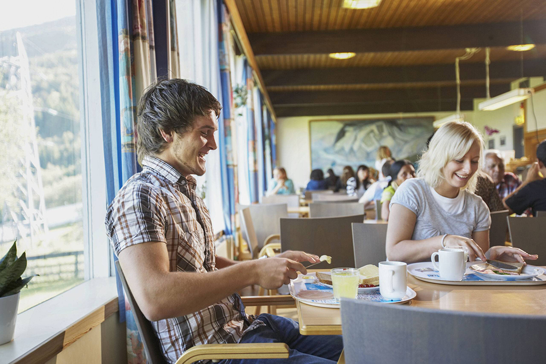 A warm breakfast atmosphere at Hostel Montana where travellers from around the world connect.