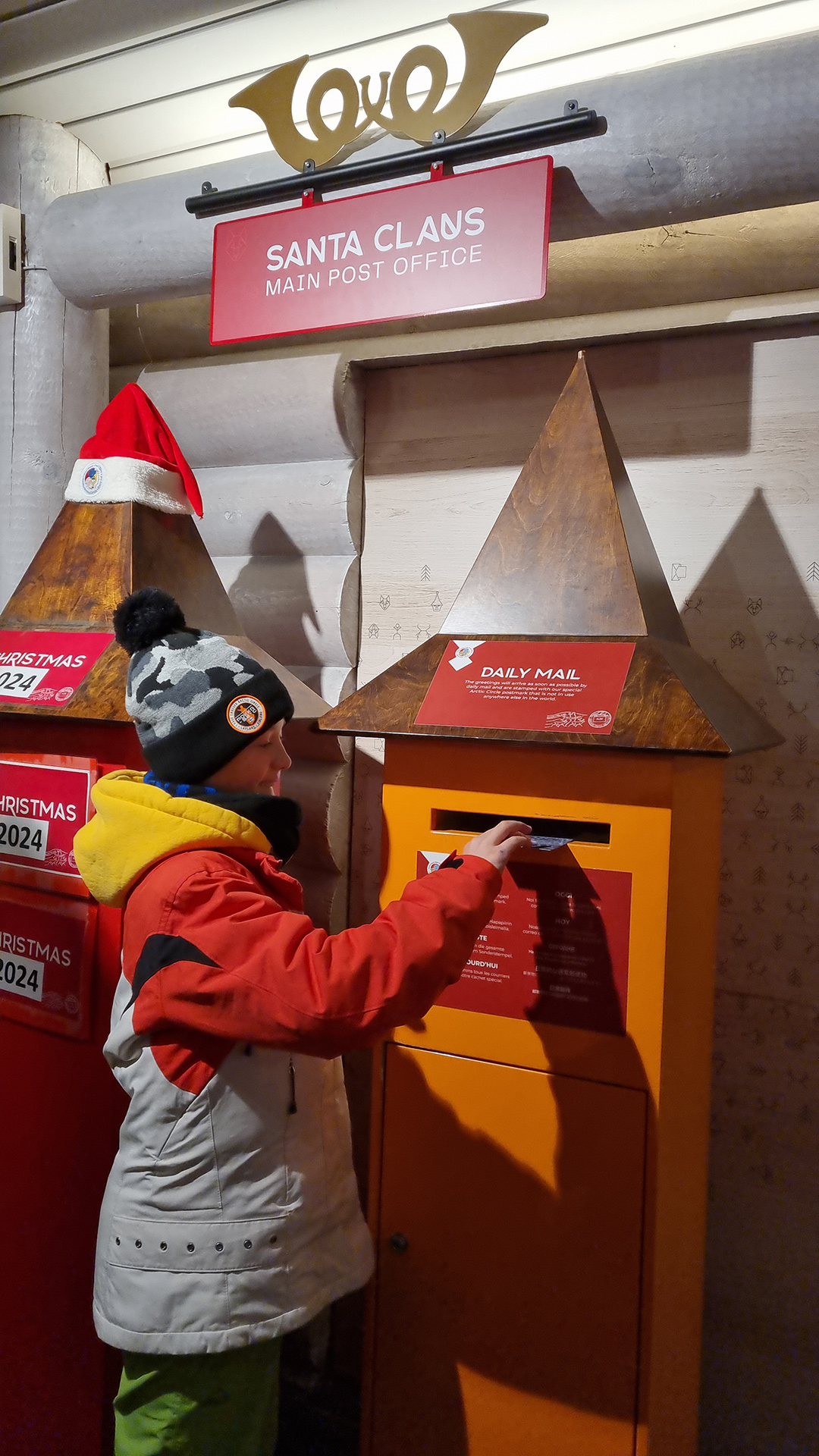 A child posting a letter at Santa Claus Main Post Office in Rovaniemi, where letters from children and adults around the world arrive in Lapland.