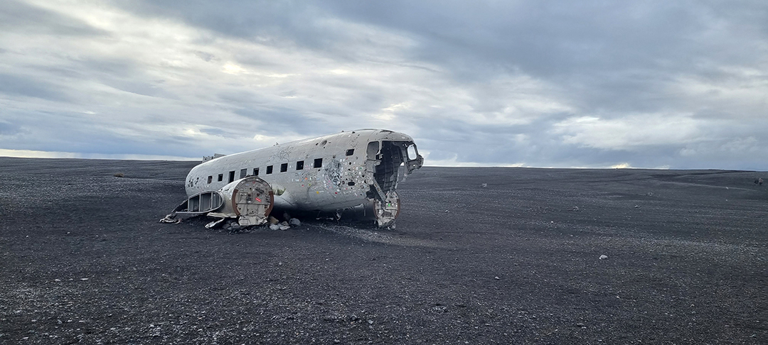 The DC-3 US Navy plane wreck resting on the black sands of Sólheimasandur, one of Iceland’s most iconic and surreal travel sights.