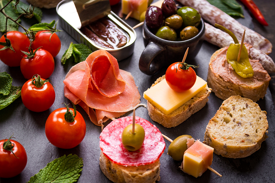 A selection of Spanish tapas represents the social food culture and richness of flavors.