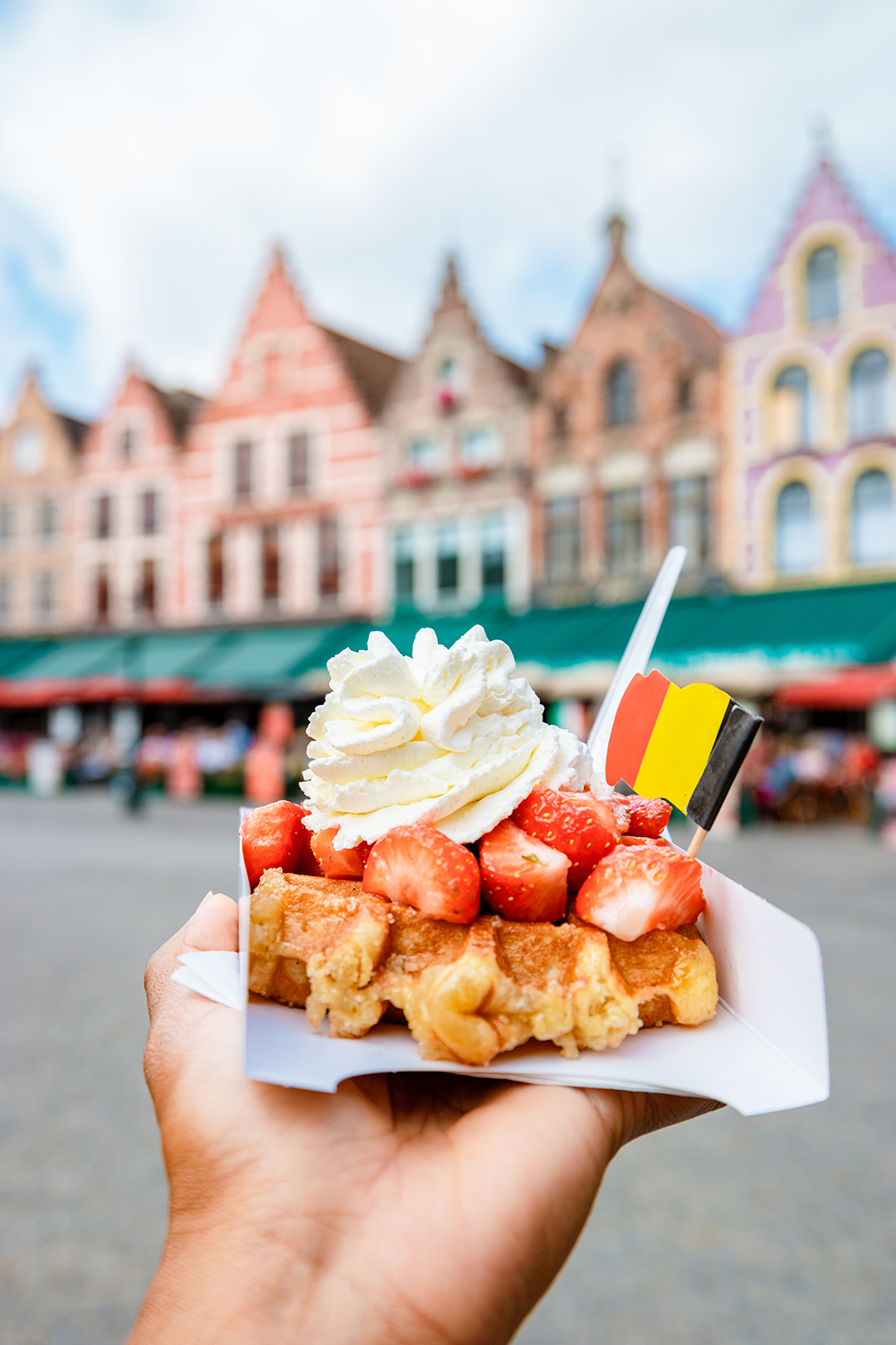 Belgian waffle with whipped cream and strawberries served in Bruges.