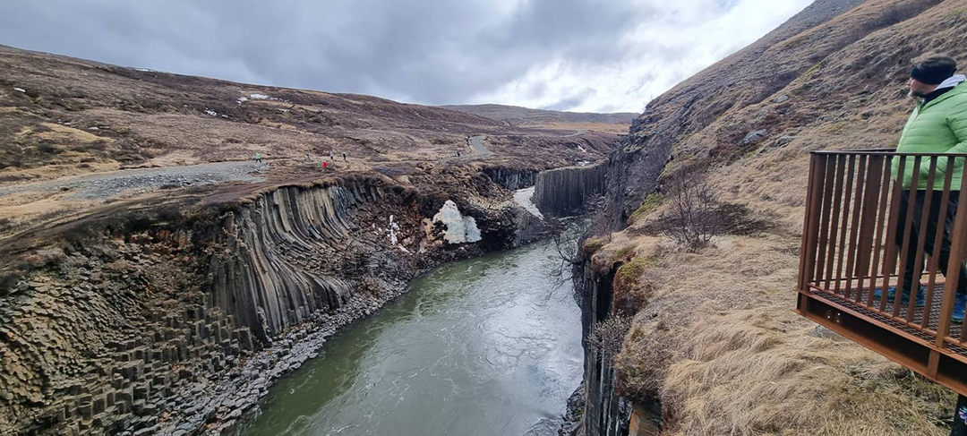 Studlagil Canyon in eastern Iceland with dramatic basalt columns and the Jokla river flowing through the gorge, one of the most fascinating geological formations in Iceland.