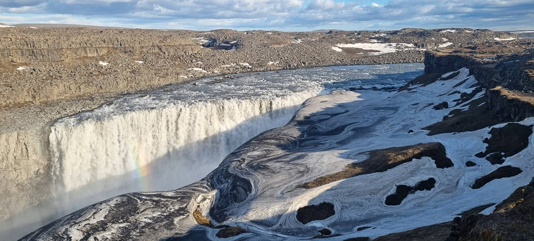 Dettifoss waterfall in northern Iceland, the most powerful waterfall in Europe where massive volumes of water crash into a deep canyon in the volcanic landscape.