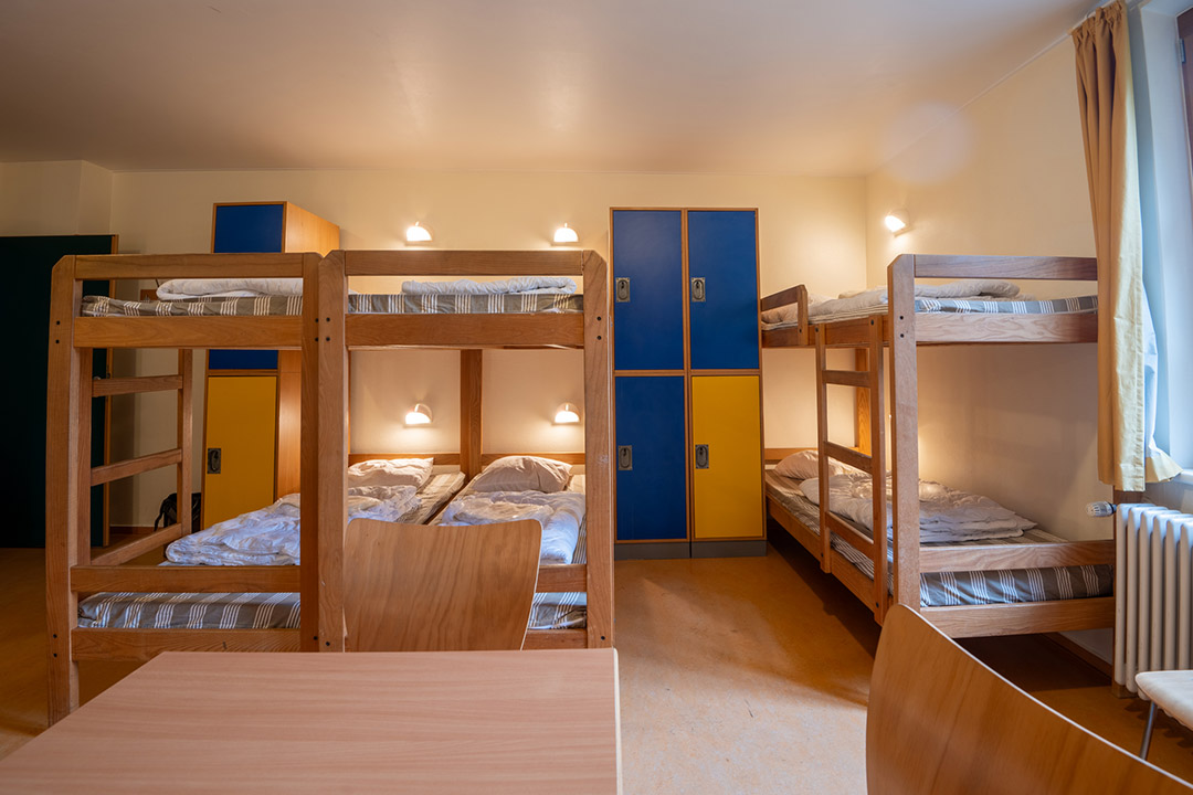 Interior of a youth hostel in Vianden with bunk beds and simple, comfortable accommodation for travellers.